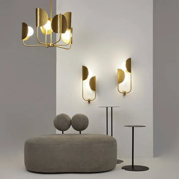 Brass-colored metal wall lamp with embossed tropical leaf motif and two white glass domes – Tropic | Maytoni
