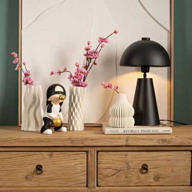 Decorative figurine made of polyresin with a sporty basketball motif, high-contrast black, white, and gold color scheme, and a playful boy figure blowing a bubblegum bubble | Wurm