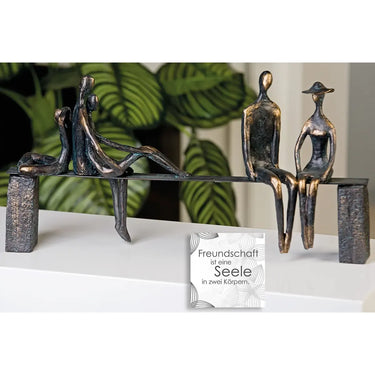 Skulptur – Bronzefarbene Figuren, Schwarze Bank, Strukturierte Oberfläche - Leisure | Gilde