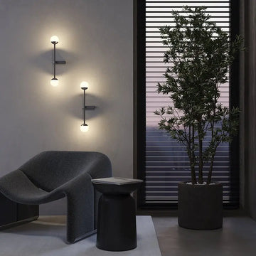 Black metal wall lamp with two white glass spheres and touch dimmer | Maytoni