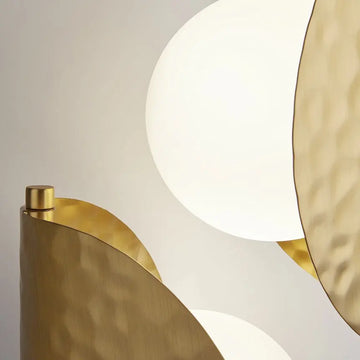 Brass-colored metal wall lamp with embossed tropical leaf motif and two white glass domes – Tropic | Maytoni