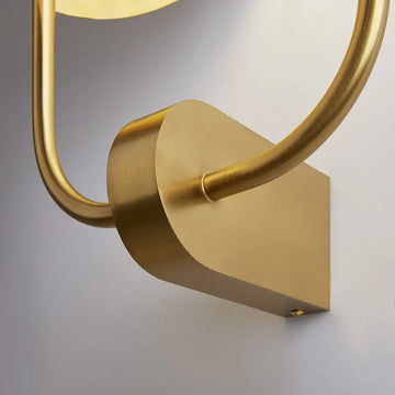 Brass-colored metal wall lamp with embossed tropical leaf motif and two white glass domes – Tropic | Maytoni
