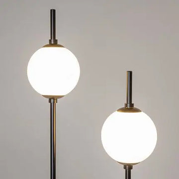 Floor lamp made of metal & glass spheres with ergonomic cross base – The Sixth Sense | Maytoni
