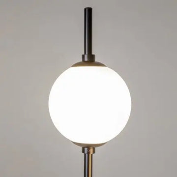 Floor lamp made of metal & glass spheres with ergonomic cross base – The Sixth Sense | Maytoni